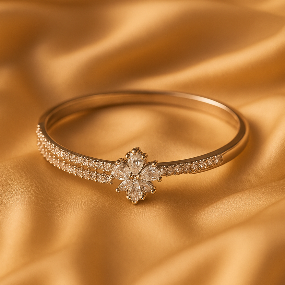 Gold floral crystal bracelet placed on golden satin fabric background