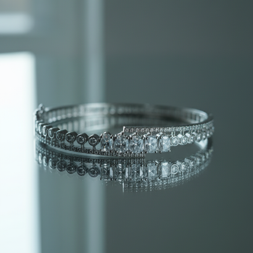 Luxury silver bracelet with sparkling crystals on reflective glass surface