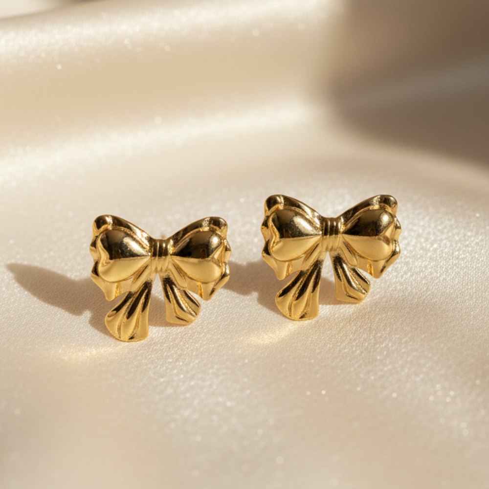 Gold bow stud earrings with shiny polished bowknot design