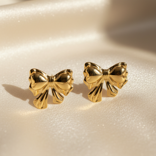 Gold bow stud earrings with shiny polished bowknot design
