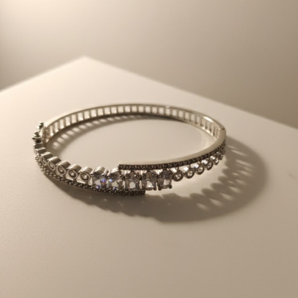 Elegant silver crystal bracelet placed on beige satin fabric