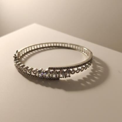 Elegant silver crystal bracelet placed on beige satin fabric