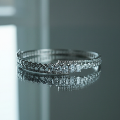 Luxury silver bracelet with sparkling crystals on reflective glass surface