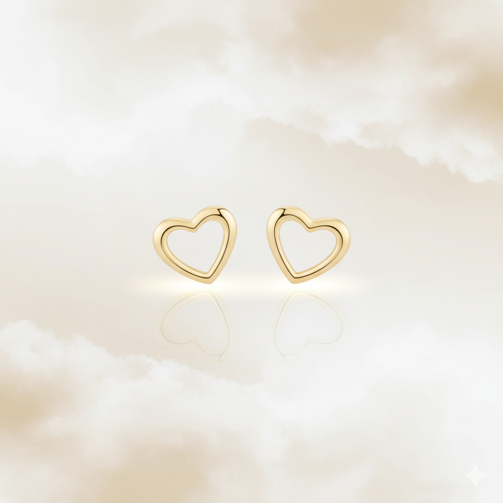 Cute minimalist gold heart earrings in dreamy soft background