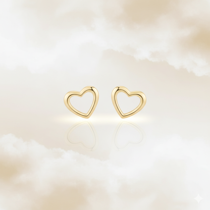 Cute minimalist gold heart earrings in dreamy soft background